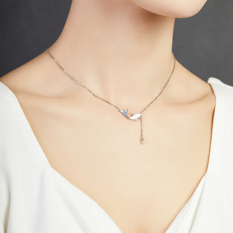 Original side view of model wearing the whale necklace