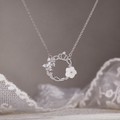 Crown wreath necklace against original taupe background and lace