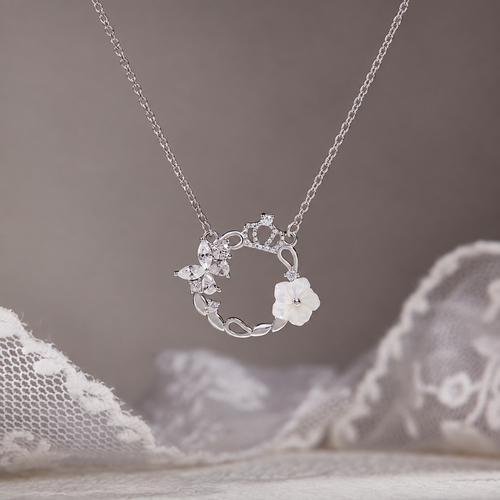 Crown wreath necklace against original taupe background and lace