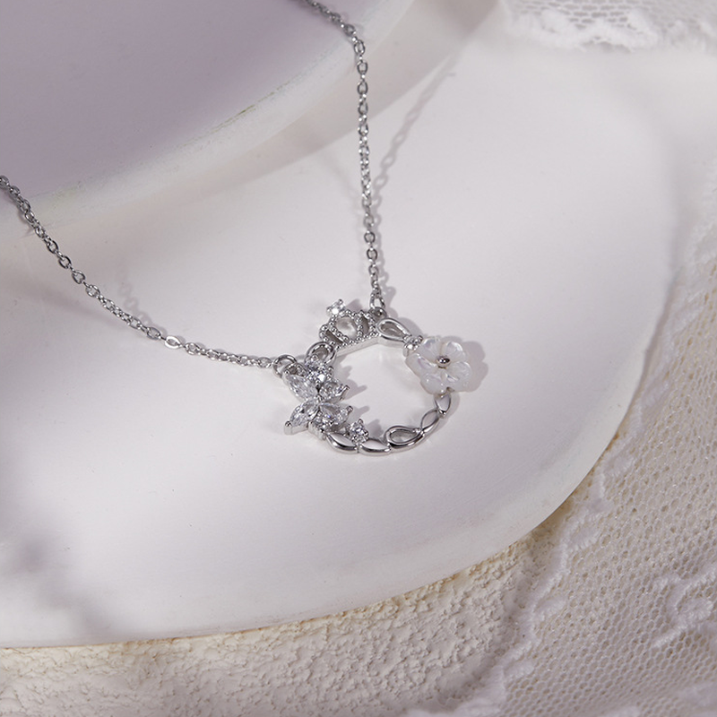 Angled crown wreath necklace on plate and lace