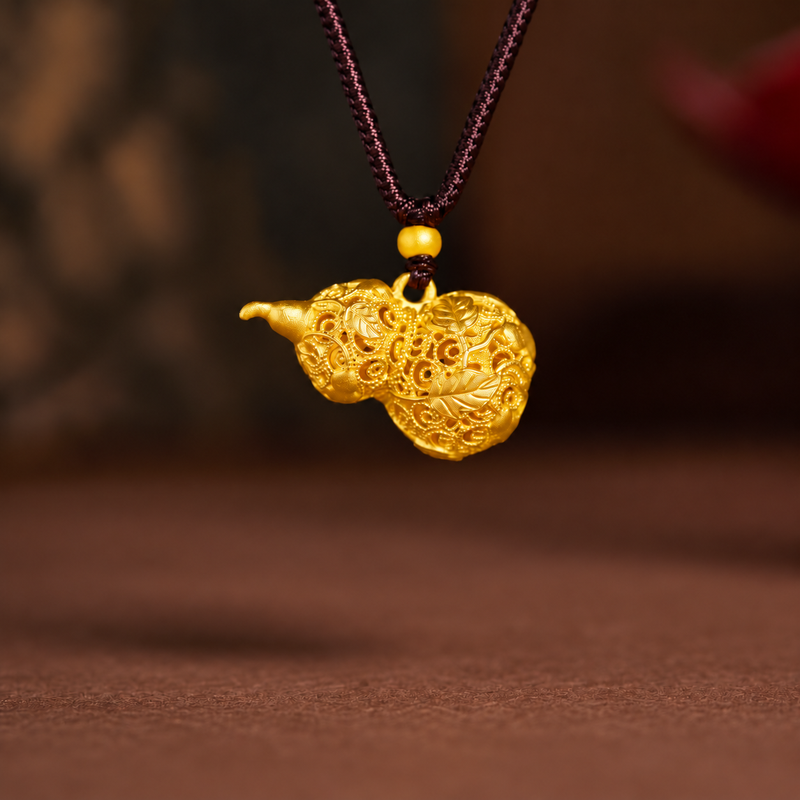 Gold-tone filigree gourd necklace against a warm brown background