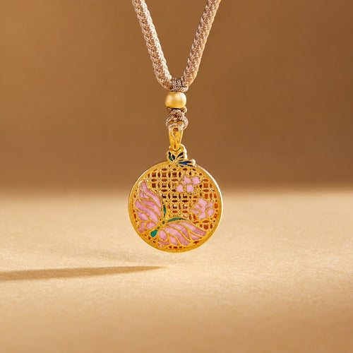 Pink enamel butterfly medallion hanging vertically against a warm golden background