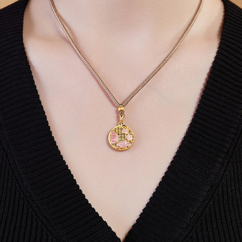 Original model wearing the butterfly medallion necklace with a black knit top