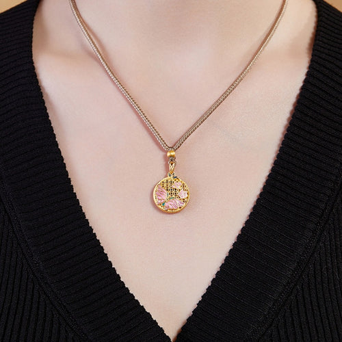 Original model wearing the butterfly medallion necklace with a black knit top