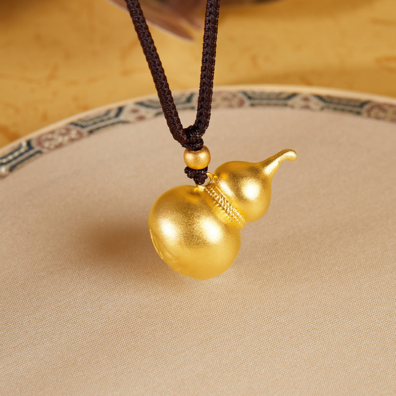 Style 2 gourd pendant with dark cord over a cream dish
