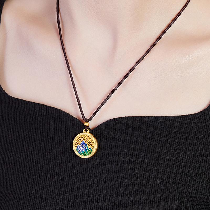 Supplier model wearing the blue-green enamel mountain necklace