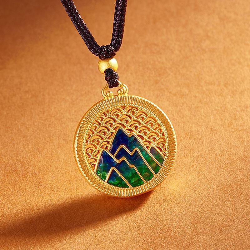 Angled view of the circular enamel mountain pendant and openwork rim