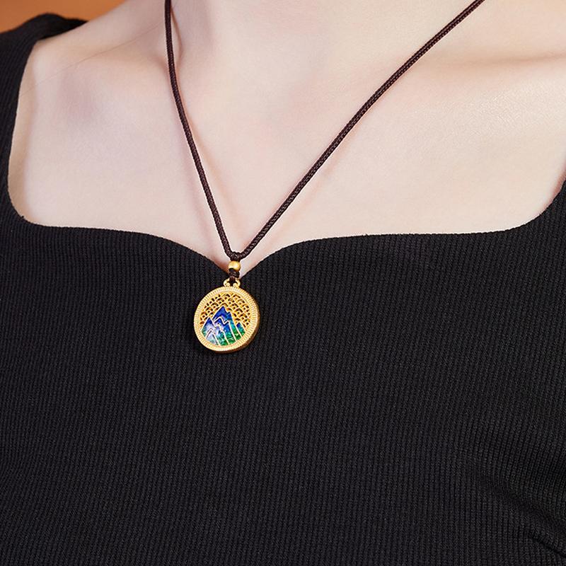 Side wearing view of the mountain landscape necklace