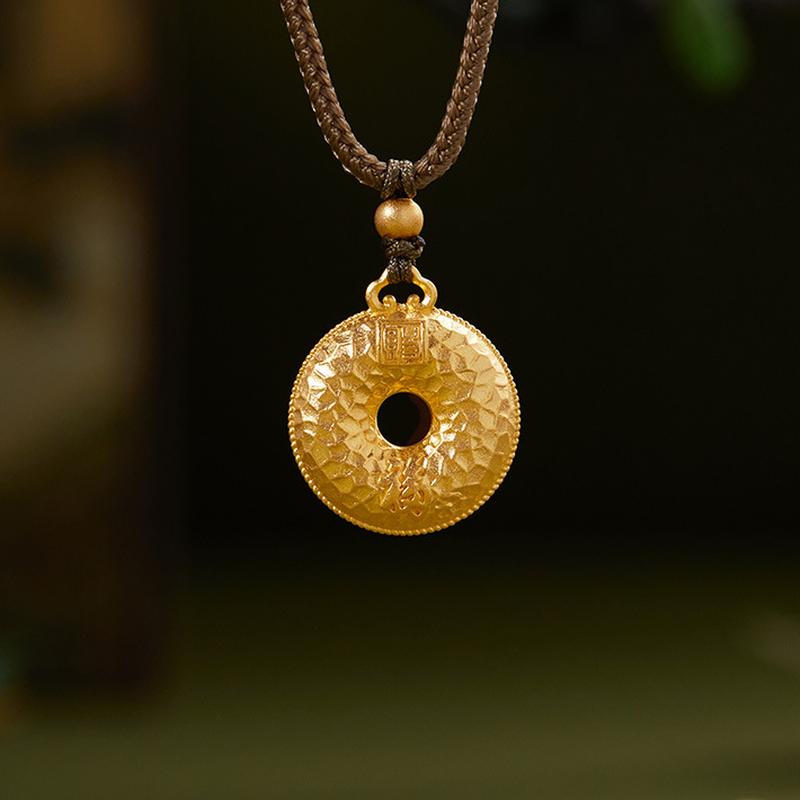 Textured peace buckle necklace with blessing motif against a natural green background