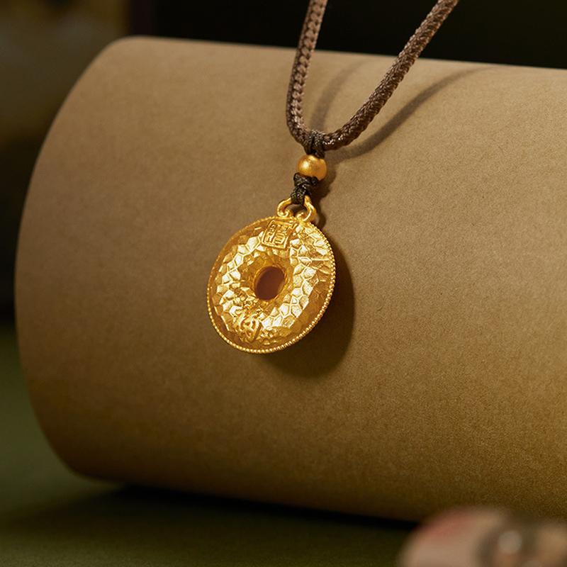 Angled view of the textured blessing pendant on a brown display