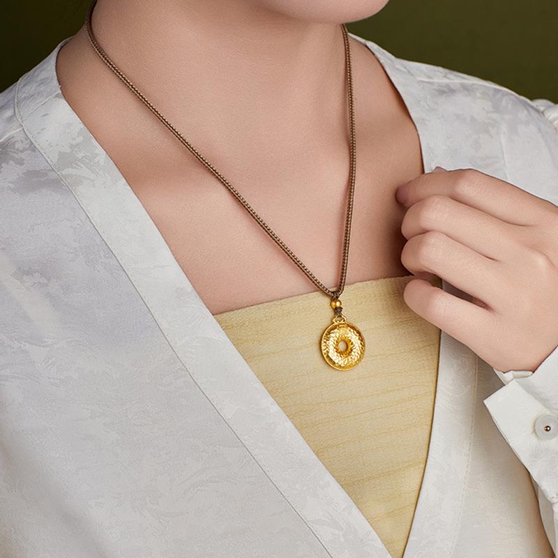 Side model view of the gold-plated peace buckle necklace