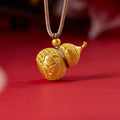 Ruyi gourd pendant in 18K gold-plated 999 fine silver on red fabric