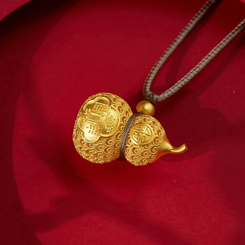 Close-up of the gourd pendant resting on red fabric