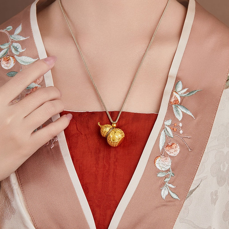 Front view of supplier model wearing the gourd necklace