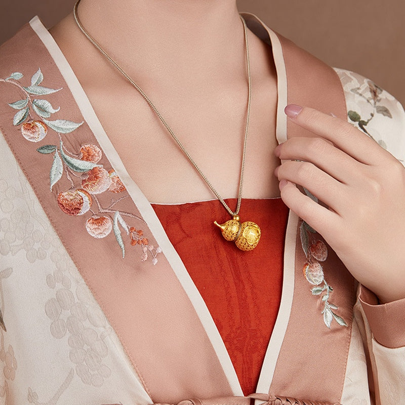 Side view of supplier model wearing the gourd necklace