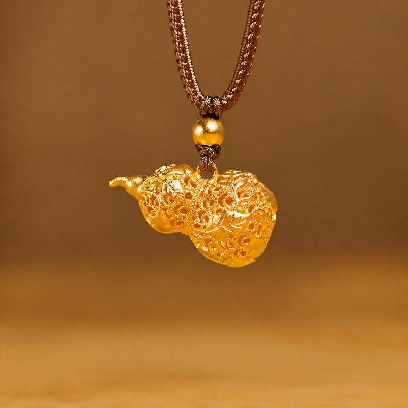 Filigree vine gourd necklace suspended against a warm brown background