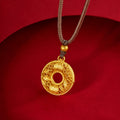 Gold-colored filigree bamboo blessing peace buckle suspended against a red background