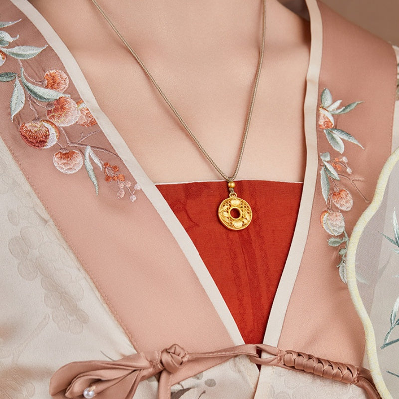 Supplier model wearing the necklace with an embroidered outfit