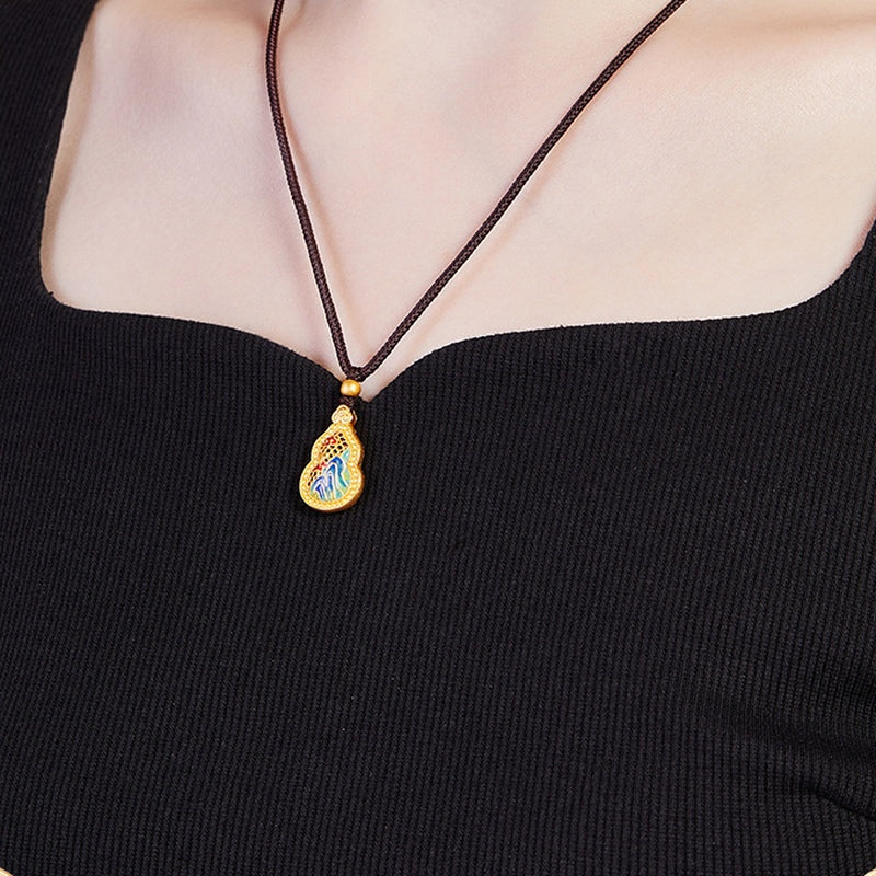 Angled view of the landscape gourd necklace worn by the original model