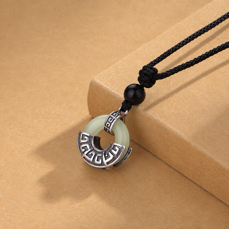 Angled peace buckle pendant leaning against a tan block