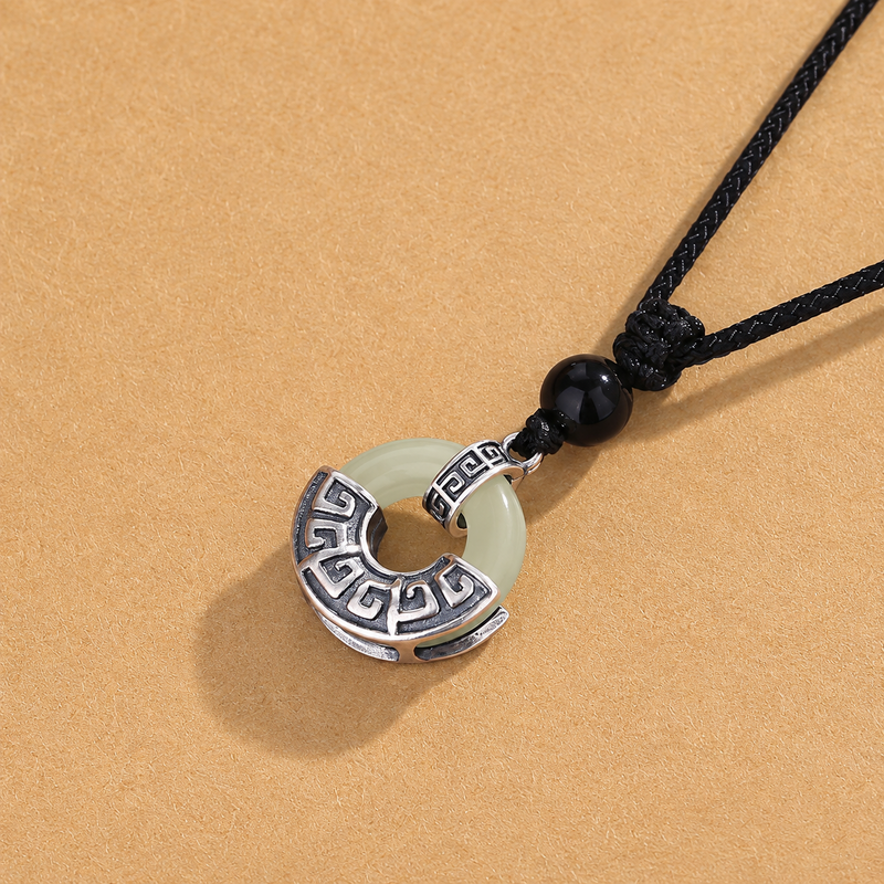 Close view of pale nephrite jade and the antiqued silver setting