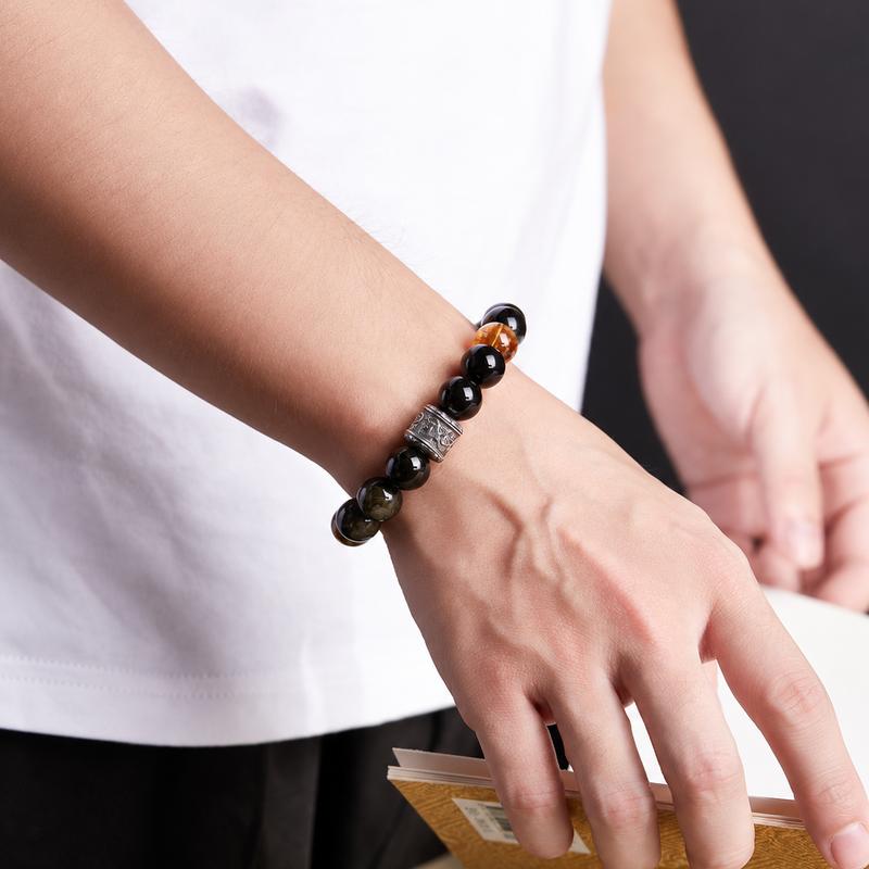 Supplier model wearing the obsidian bracelet while holding a book