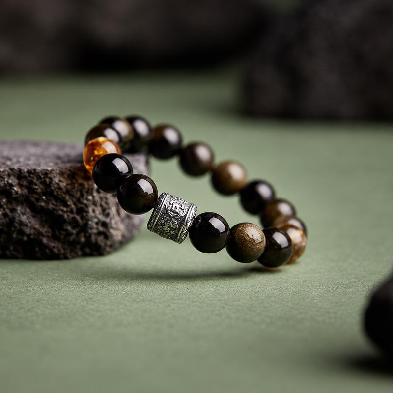 Oblique close view of the obsidian bracelet and engraved barrel