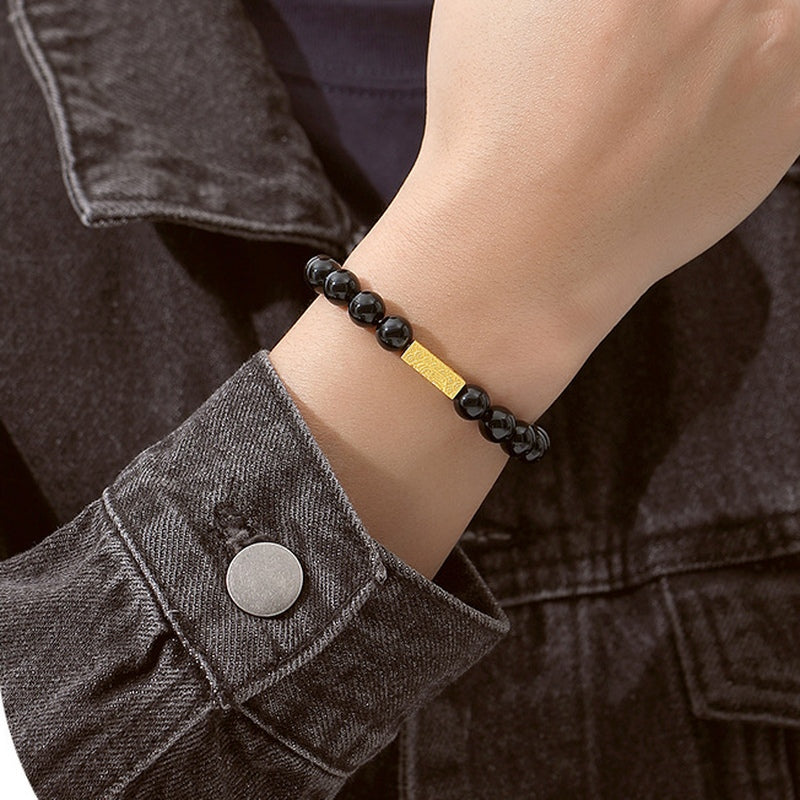 Original model close view of the gold blessing bar and black obsidian beads