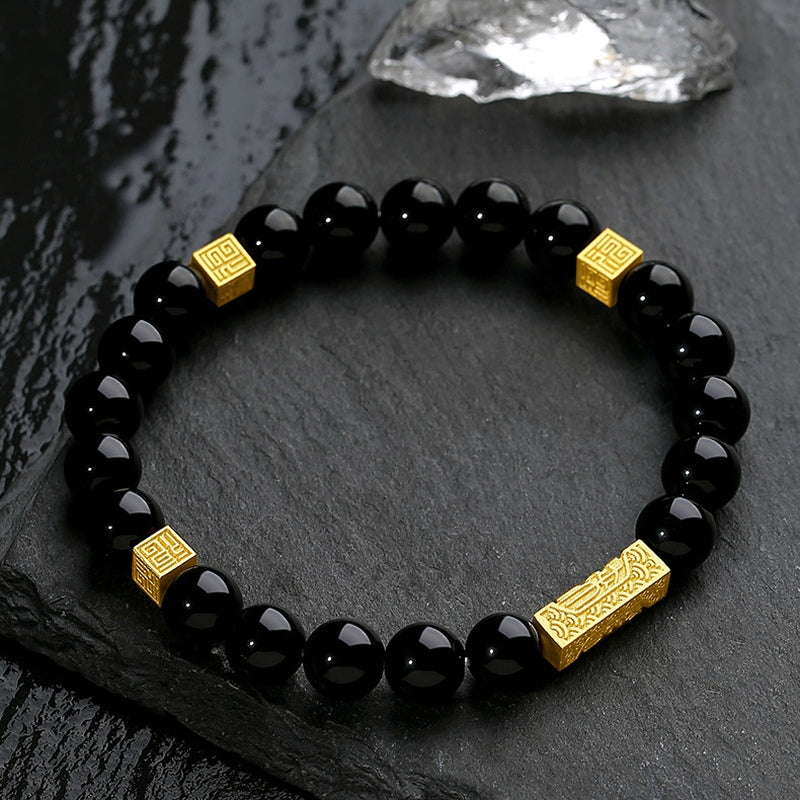 Black obsidian bracelet with one gold blessing bar and three square blessing accents