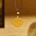 Single magpie filigree ruyi lock necklace hanging against its warm ochre background
