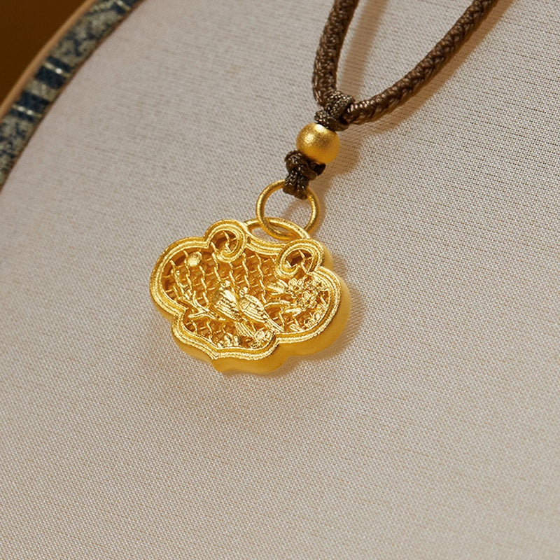 Magpie and plum openwork ruyi lock pendant resting on a fabric fan