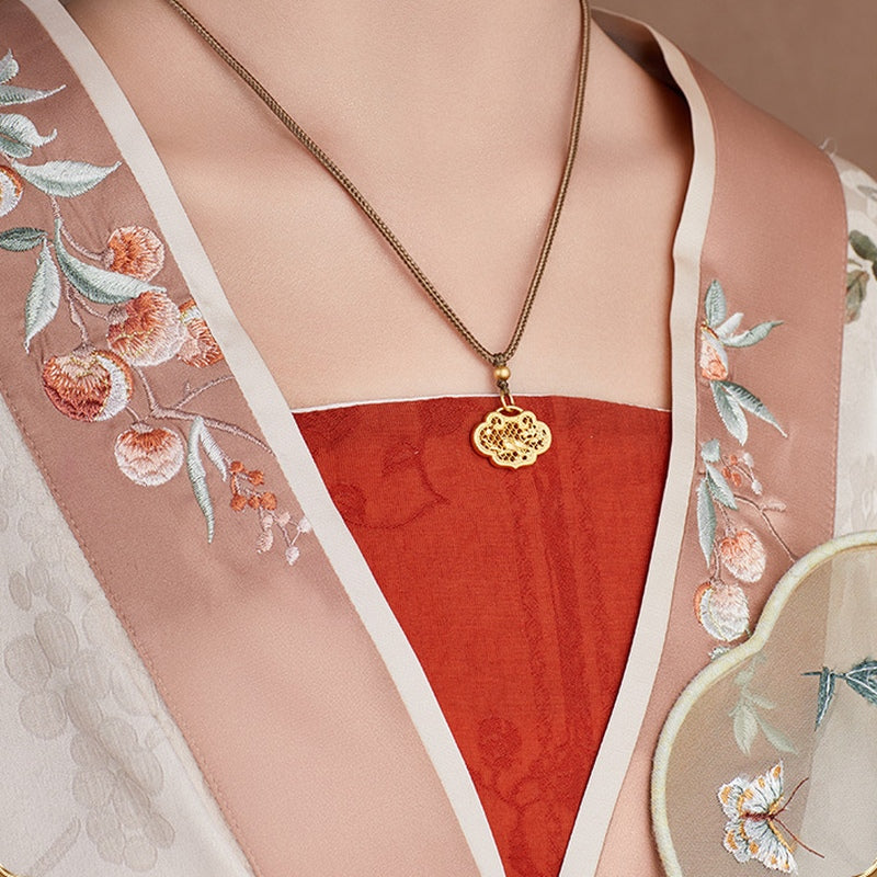 Angled view of the original model wearing the magpie ruyi lock necklace