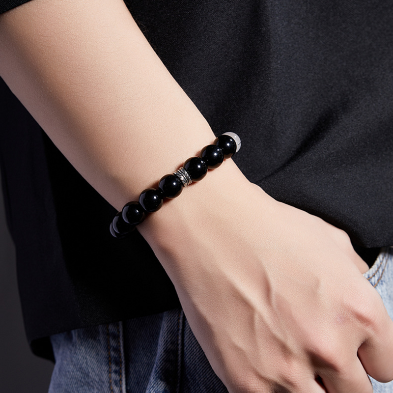 Original model wearing the feather obsidian bracelet with black shirt and jeans