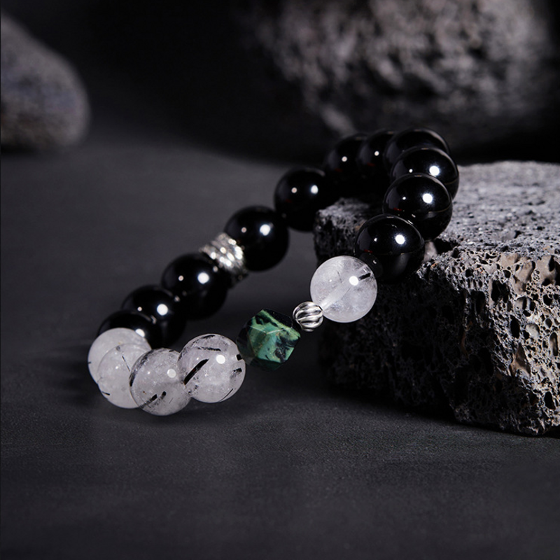 Angled original view of the obsidian and black-inclusion quartz bracelet