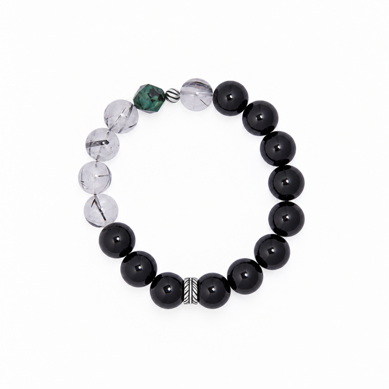 Light-background bracelet view showing obsidian, black-inclusion quartz and green accent