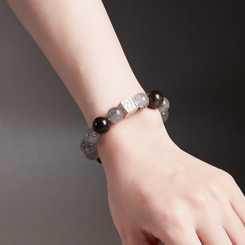 Supplier model wearing the quartz and silver sheen obsidian bracelet