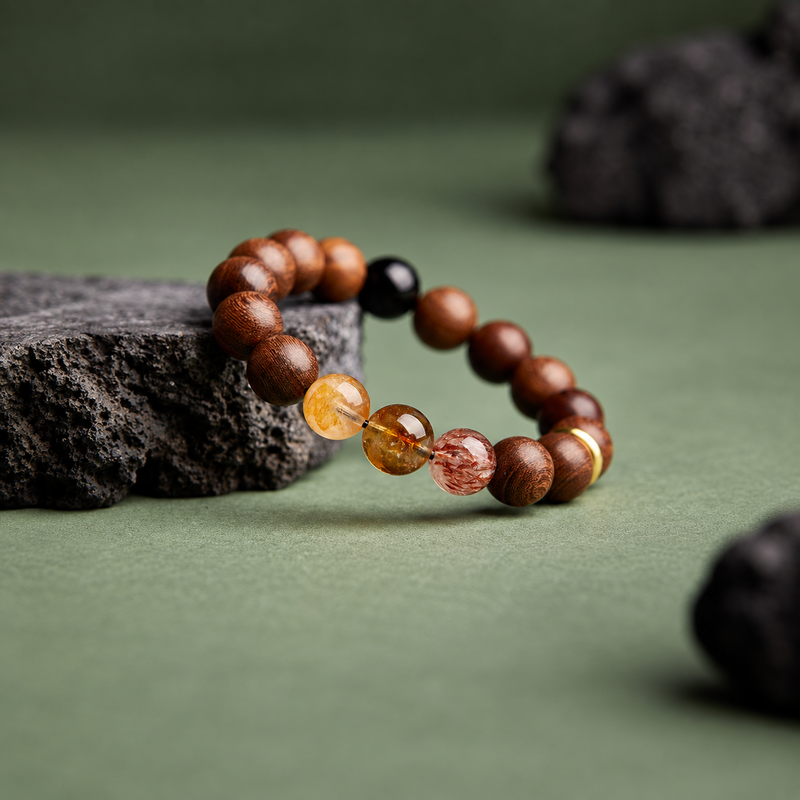 Angled view of the wood and crystal bracelet resting against dark stone