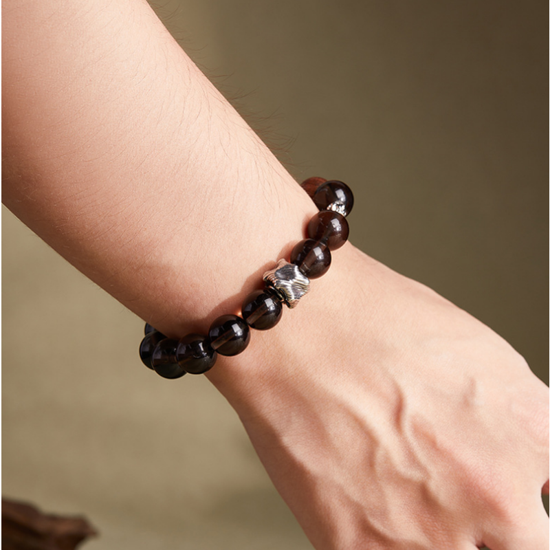 Supplier model wearing the obsidian and golden silk wood bracelet