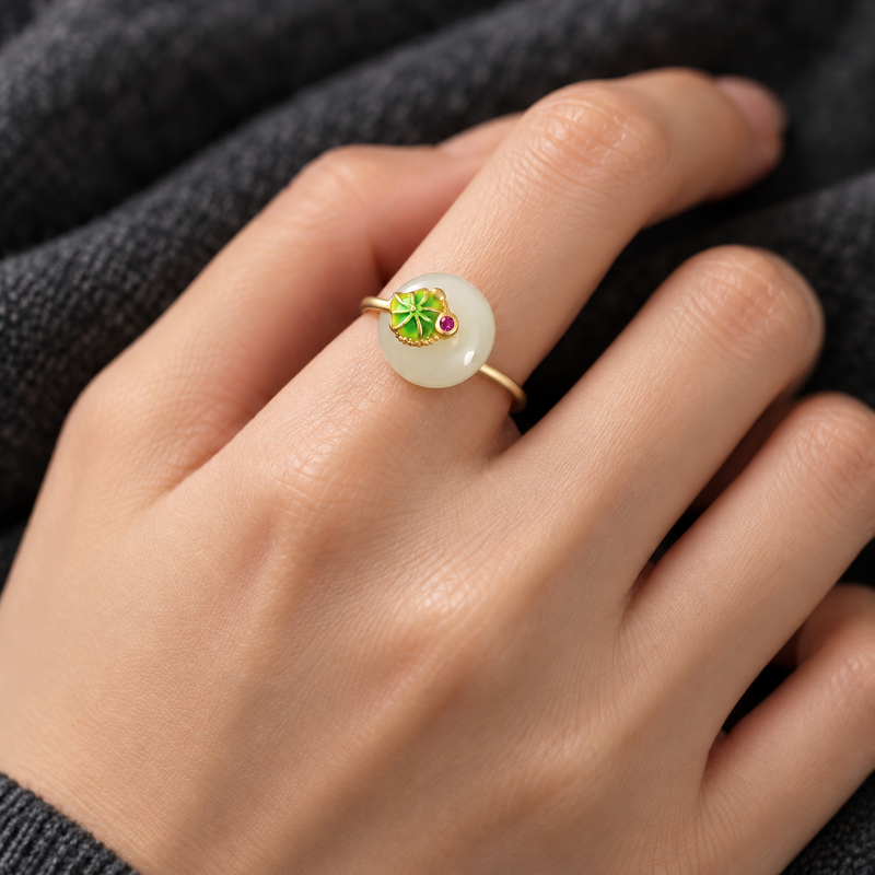 Illustrative try-on showing the small lotus leaf nephrite jade ring on a woman's hand