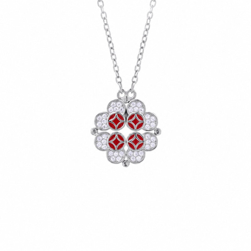 Front view of the silver and red enamel clover pendant on white