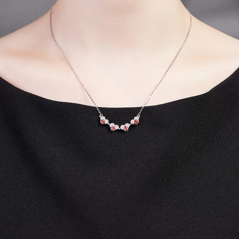 Original model wearing the necklace in its unfolded heart form