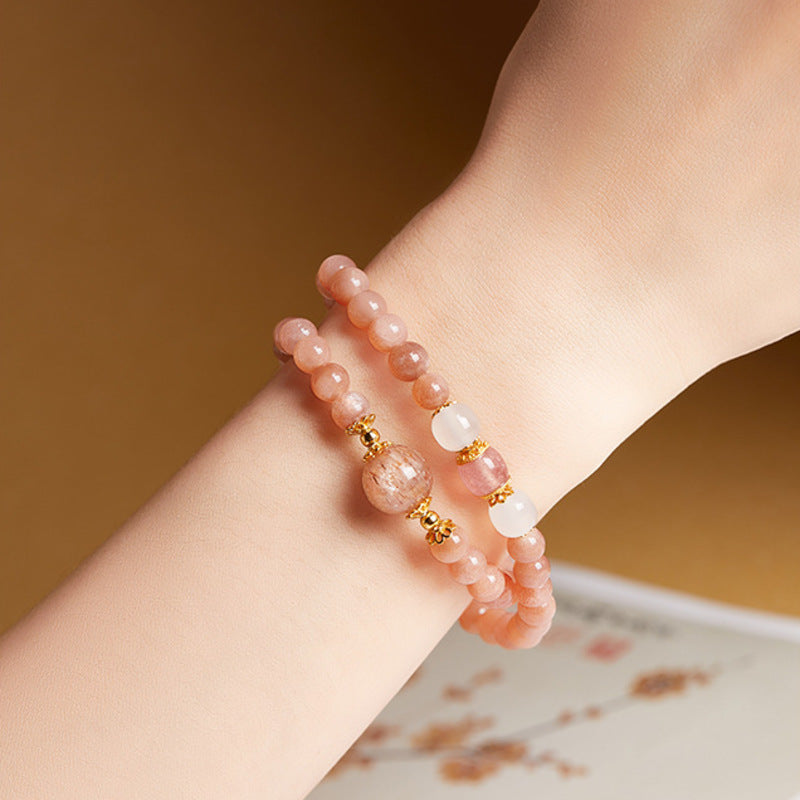 Sunstone freshwater pearl double-wrap bracelet worn on wrist