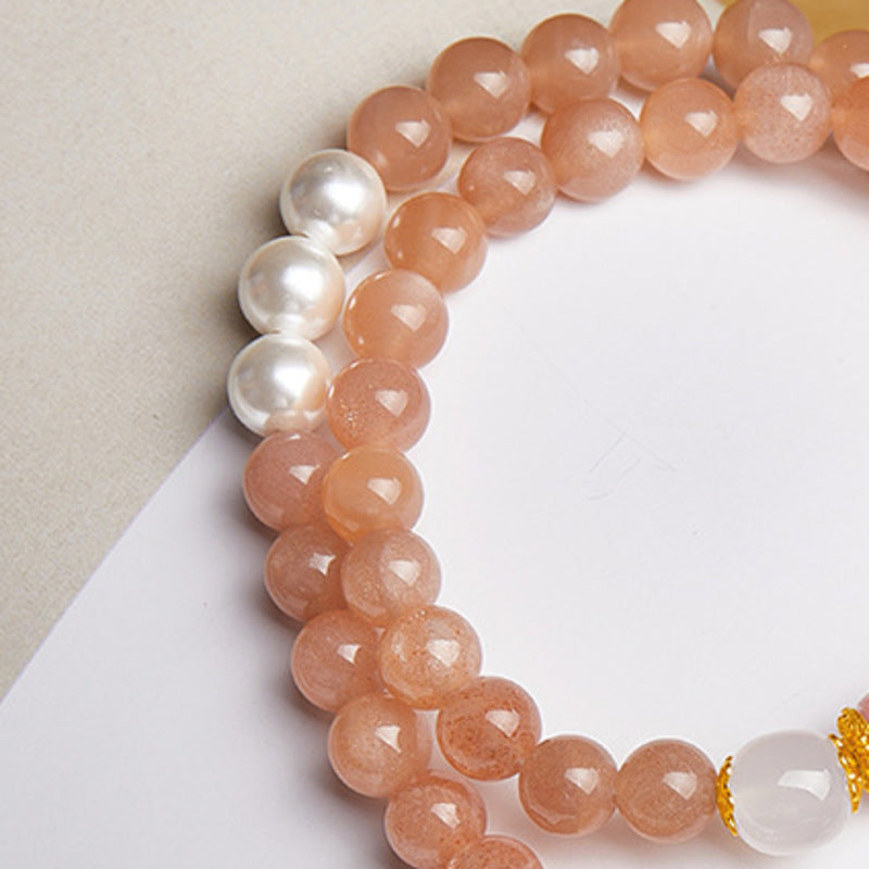 Close-up of faceted sunstone beads and freshwater pearls