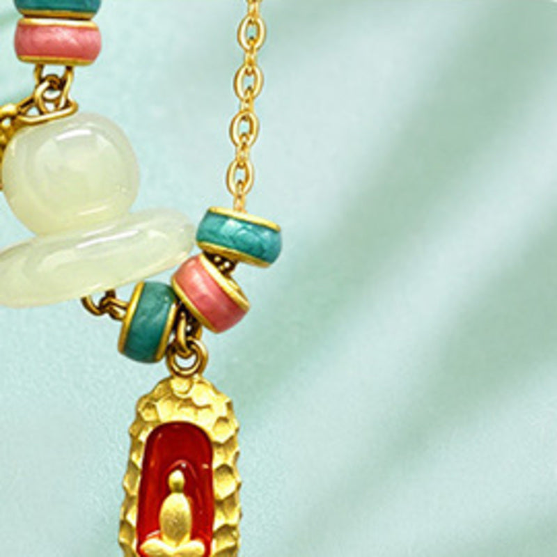 Close-up of nephrite jade and Buddha charm necklace details
