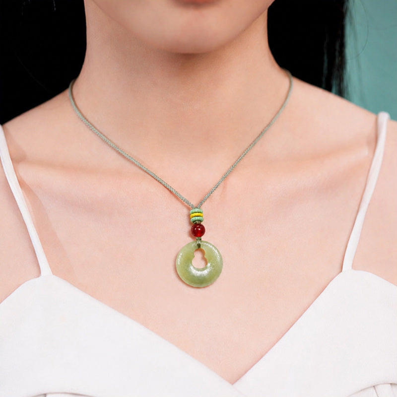 Model wearing nephrite jade gourd peace buckle pendant