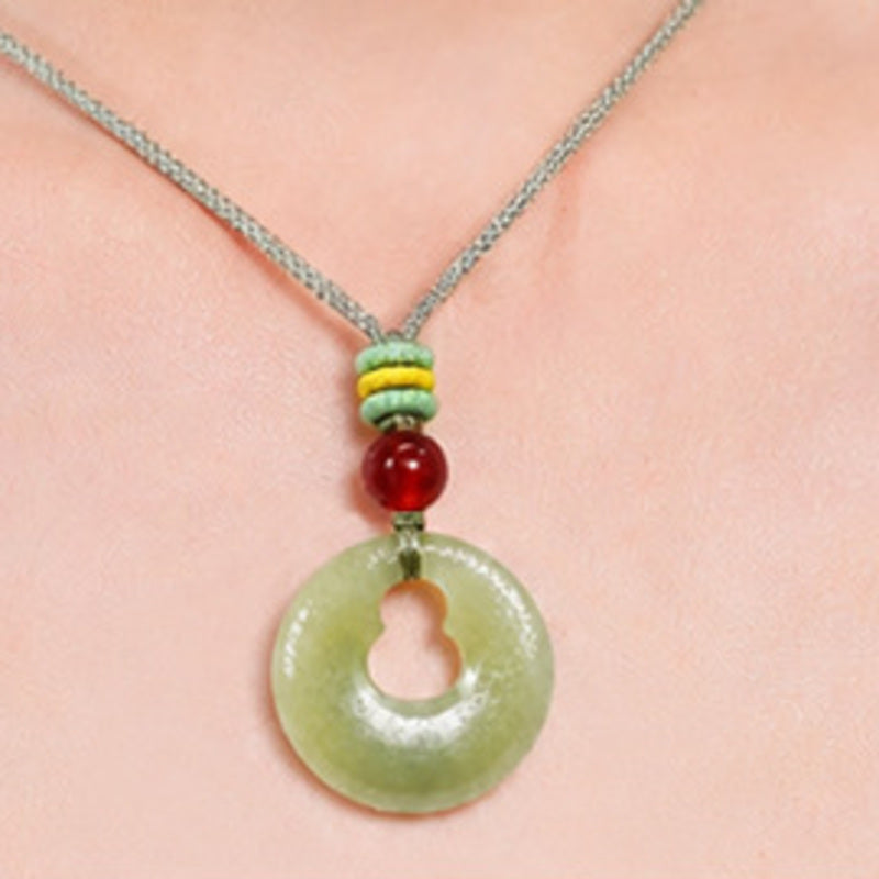 Close-up of hand-braided cord and nephrite jade gourd pendant
