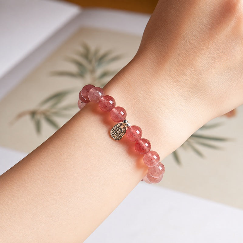 Strawberry crystal blessing plaque bracelet worn on wrist