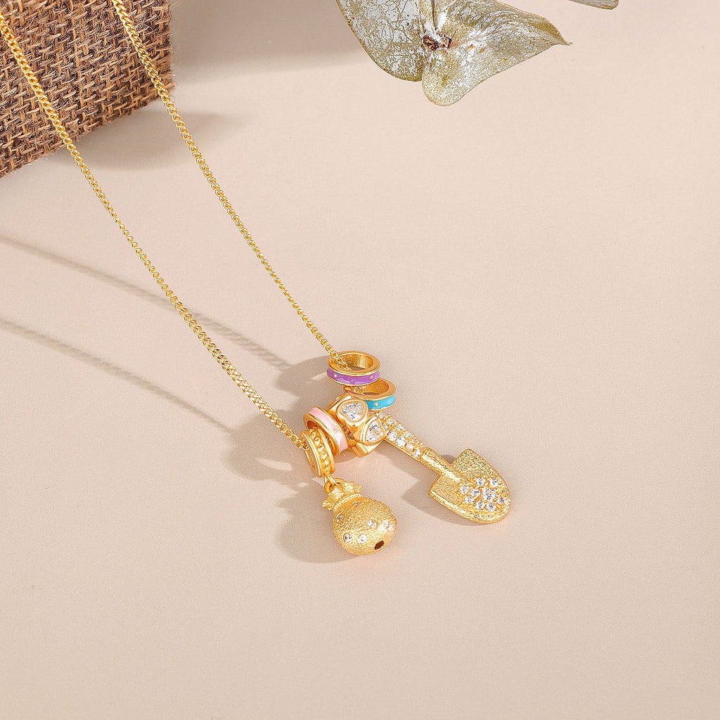 Gold Shovel & Blessing Pouch Necklace – Dig for Joy and Blessings