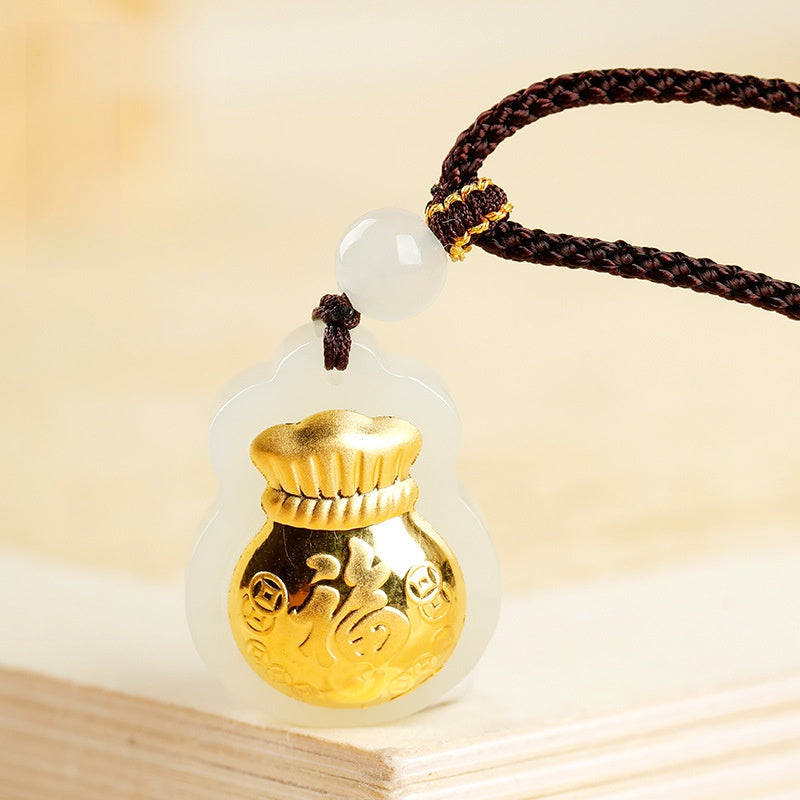 Close-up of gold-plated fortune pouch relief on white nephrite jade