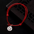 Adjustable red string bracelet with a silver Tiger zodiac charm and polished red bead.